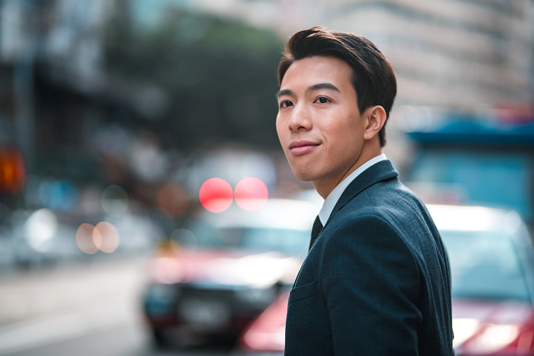 Man in suit crossing traffic